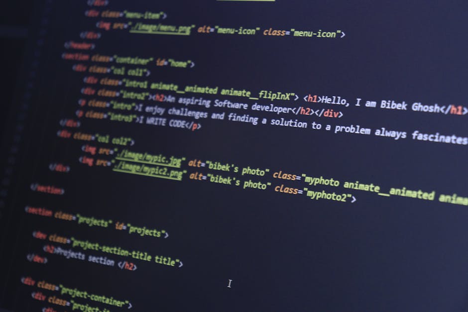 Photograph of a computer screen displaying colorful lines of programming code in various hues such as red, green, yellow, blue, and white. The code is blurred, making specific syntax and function name